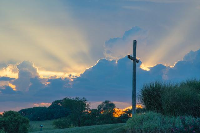 A picture of a towering cross in the grass