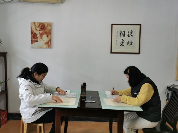 Two female members of Apostle Church in Suzhou, Jiangsu, proofread the newly transcribed Suzhou dialect version of the New Testament published in 1881 on March 16, 2023.