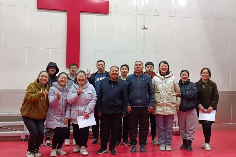 The author (fourth from the left) took a group picture with church leaders and believers of Jiangxian County in Yuncheng City, Shanxi Province, during a visit in March or April, 2023.