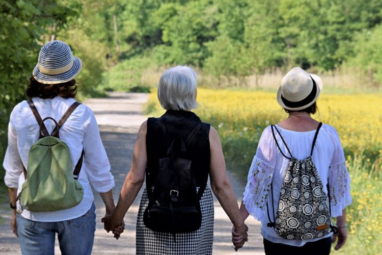 A picture of three women holding hands