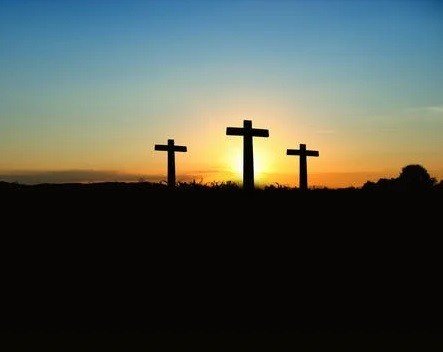 A picture of three crosses on the mountain