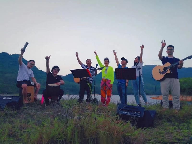 A picture of some believers worshipping God outdoors