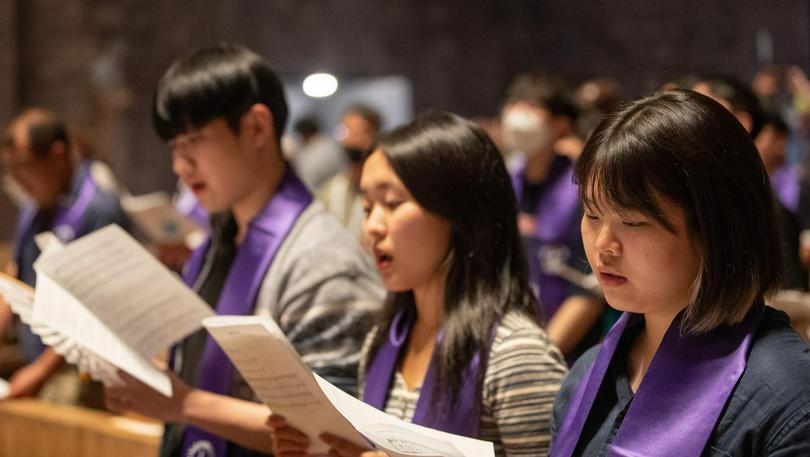 5 September 2022, Karlsruhe, Germany: Participants pray during a service for peace and reunification between South and North Korea at St. Stephan Church in Karlsruhe as part of the World Council of Churches' 11th Assembly. The assembly takes place August 31 to September 8 under the theme 