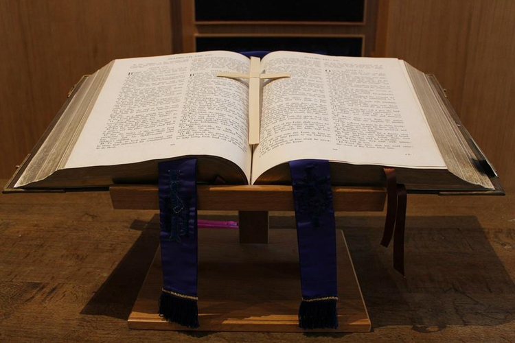 A picture of a big bible with a cross on it