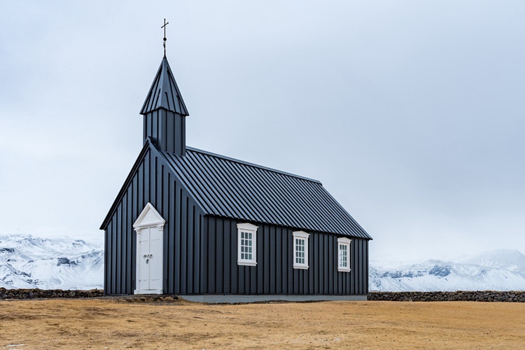 A church besides a snowy mountain