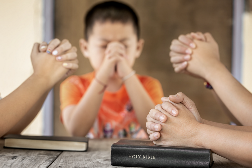 A picture of a Christian family worshiping God in home