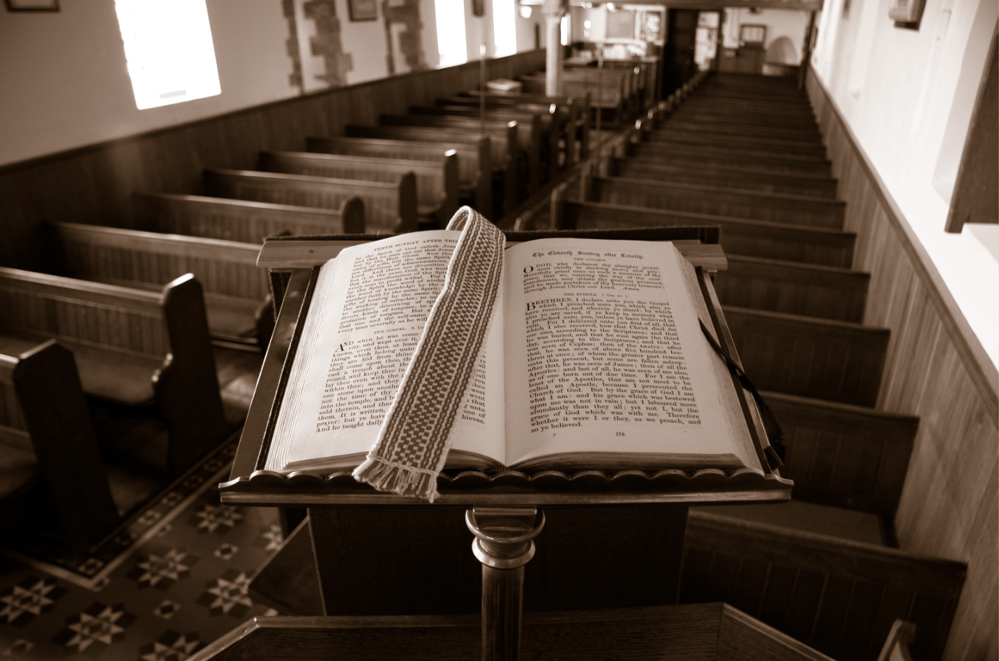 A picture of the church interior with an opened Bible on the podium