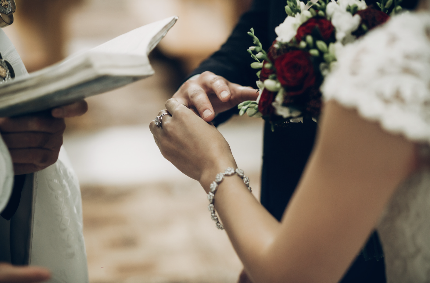 A wedded couple exchange wedding rings on the ceremony.