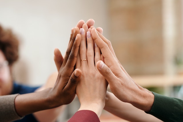 A group of people put their hands together.
