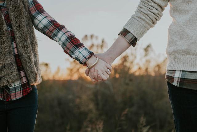 A picture of a man and a woman holding hands