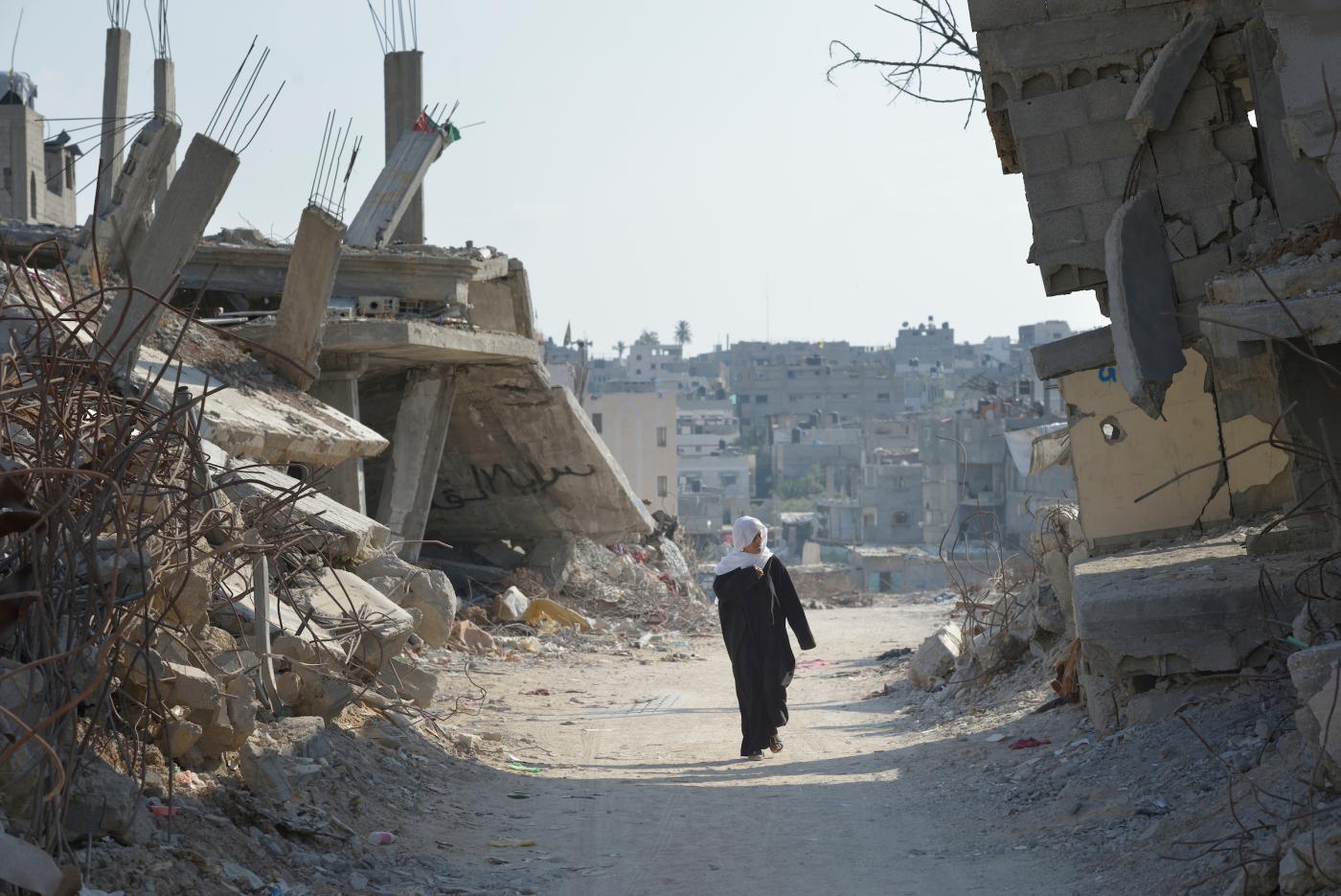 A woman walks through Shejaiya, a Gaza neighborhood which bore the brunt of some of the most intense Israeli air attacks during the 2014 war. Throughout Gaza, members of the ACT Alliance are supporting health care, vocational training, rehabilitation of housing and water systems, psycho-social care, and a variety of other humanitarian activities.