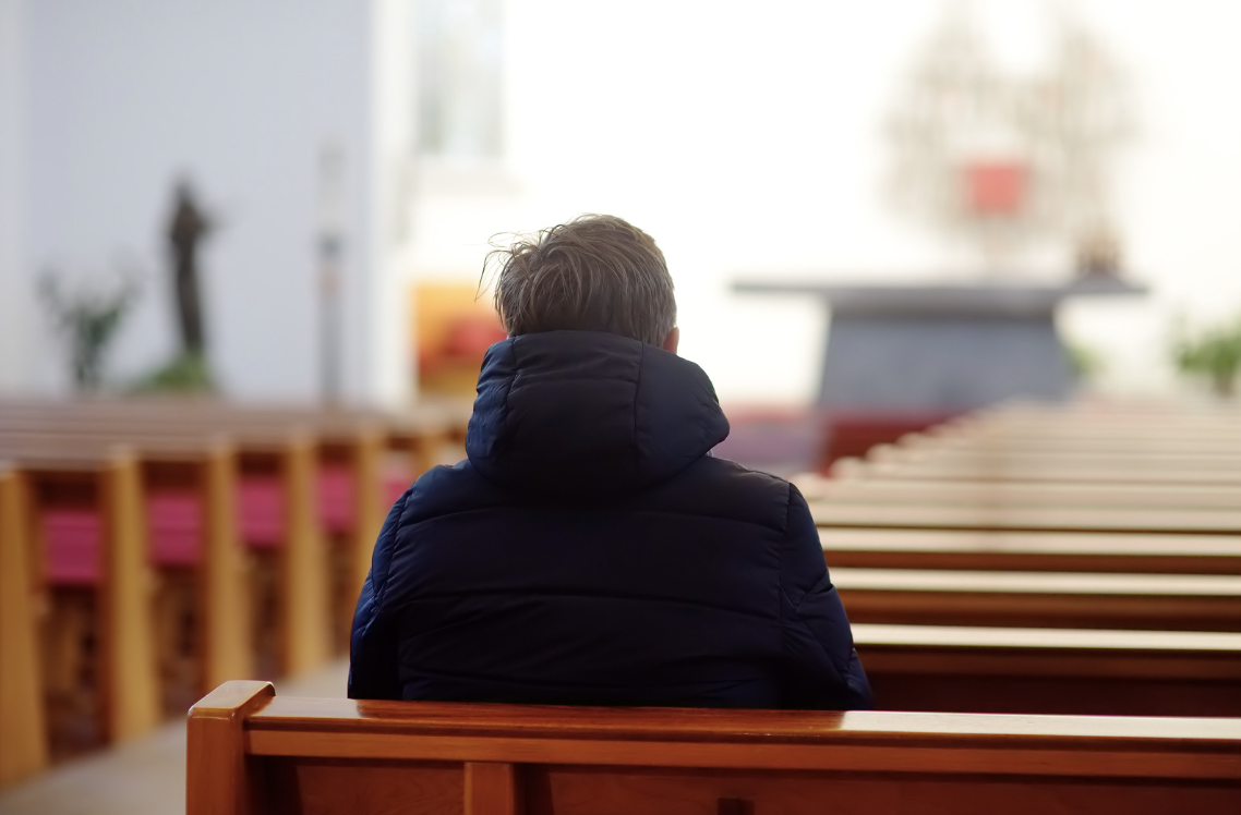 A man sits in a church.
