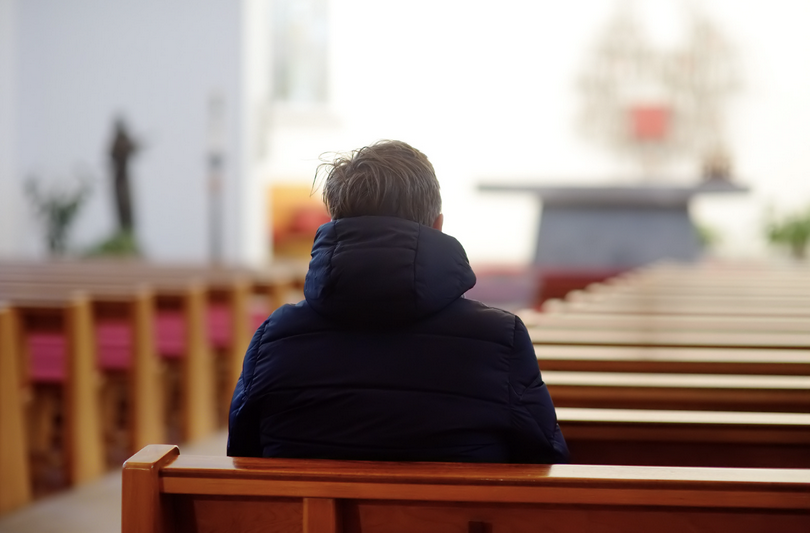 A man sits in a church.