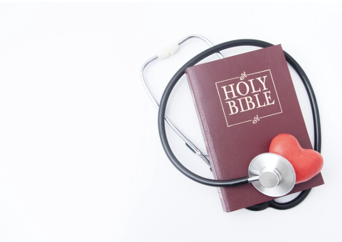 A picture of a Bible and a red heart with a medical stethoscope