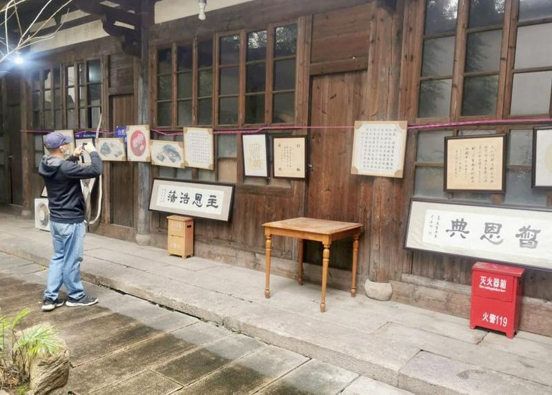 A believer took a photo of the calligraphy paintings that were exhibited during the Spring Festival calligraphy exhibition held by the Huaxiang Church in Fuzhou City, Fujian Province, on February 4, 2024
