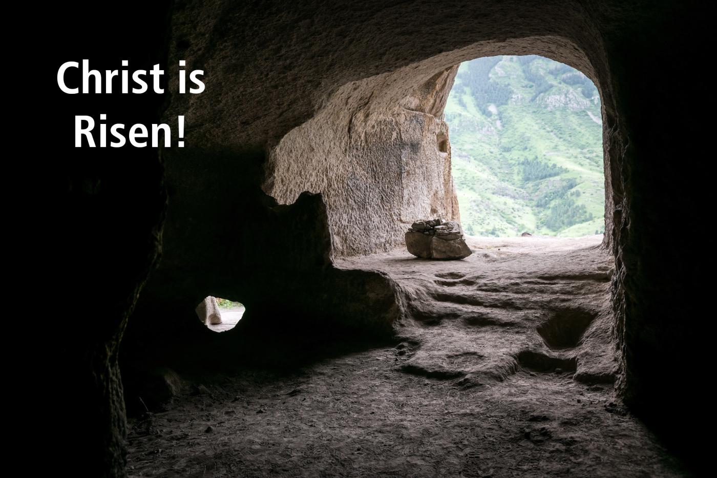 A picture of a cave taken from inside with the text "Christ is Risen"