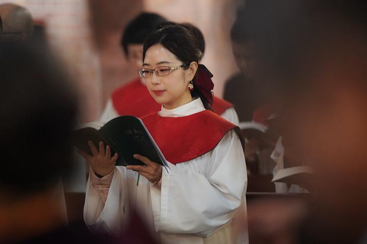 A choirwoman was singing a hymn during the Palm Sunday service conducted at Holy Trinity Cathedral in Shanghai on March 24, 2024.