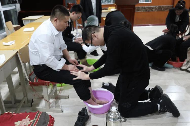 Believers prayed during a foot-washing ceremony at Heilongjiang Theological Seminary on Maundy Thursday, March 28, 2024.