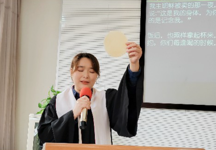 A woman pastor consecrated the bread during a foot-washing and communion service at Shishan Church, Suzhou, Jiangsu, on Maundy Thursday, March 28, 2024.