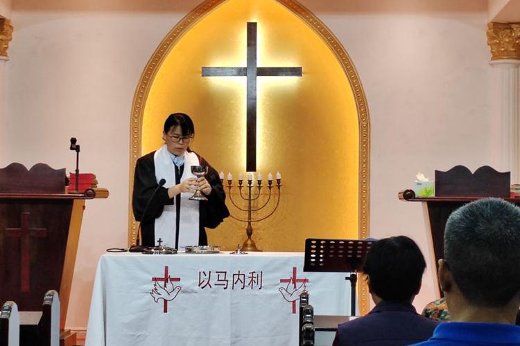 A woman pastor consecrated the wine during a communion service at Beijiao Church in Foshan, Guangdong, on Maundy Thursday, March 28, 2024.