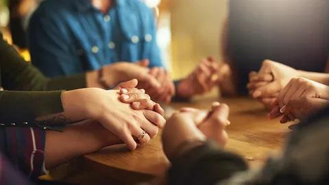 A picture of a group of people holding hands