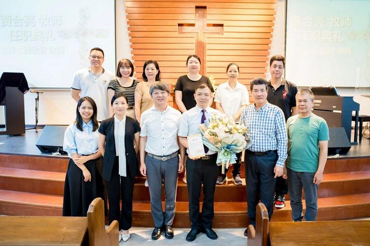 A group picture was taken when Rev. Jia Heliang (with flowers) was appointed as the head of Liangdu Church in Zhongshan, Guangdong, on May 12, 2024.    