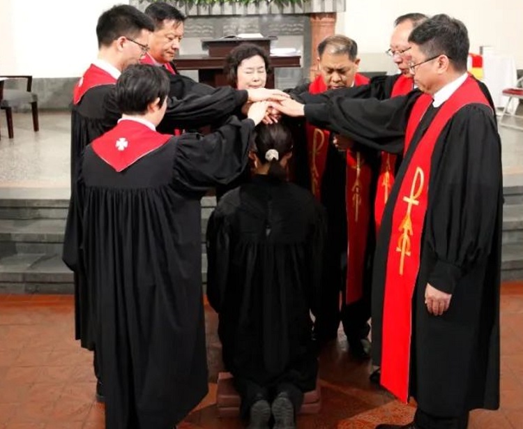 The pastorate raised their hands on a female church worker during an ordination ceremony conducted at Jiangsu Road Church in Qingdao, Shandong, on May 19, 2024.