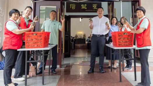 The staff members of Union Church in Guangzhou, Guangdong held wrapped zongzi or rice dumplings in their hands on June 9, 2024.