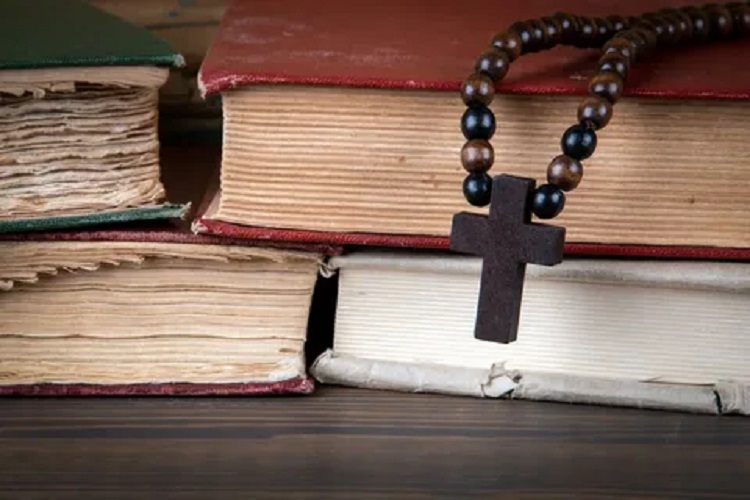 A cross on old books