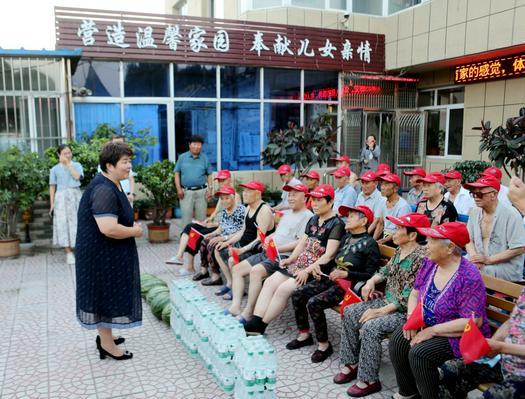 Rev. Bai Yue'e, bringing bottled mineral water and fresh local watermelons, talked with elderly residents at the Hengcai Senior Apartment in Liaozhong District, Shenyang, Liaoning, on July 17, 2024.