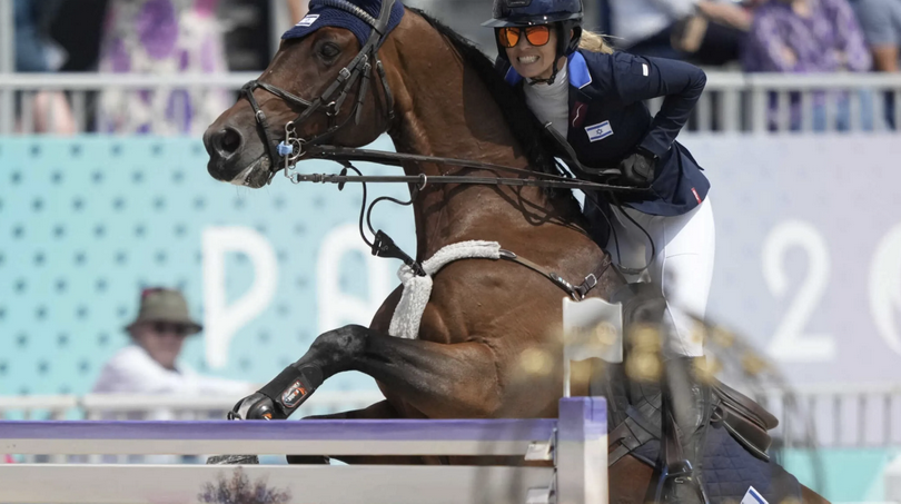 Israel's Ashlee Bond riding Donatello 141 clears a hurdle during the Equestrian Jumping Team final at the 2024 Summer Olympics, Friday, Aug. 2, 2024, in Versailles, France.