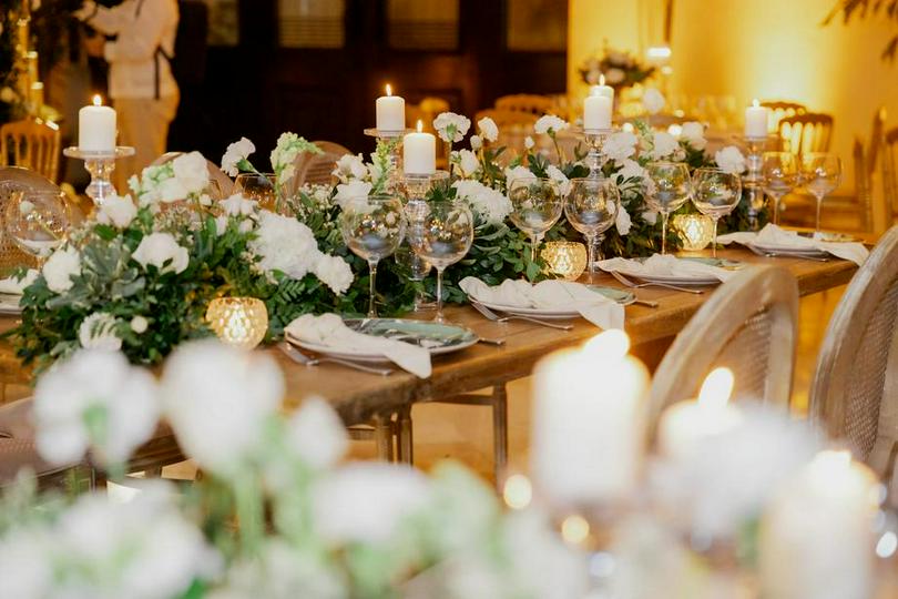 A table set for a formal dinner with candles and flowers.