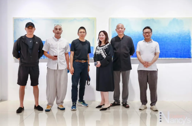 A group photo was taken during the opening of artist Hei Yue Ji Shengli's (2nd from left) art exhibition "Life in Blue" in Shanghai on September 6, 2024. 