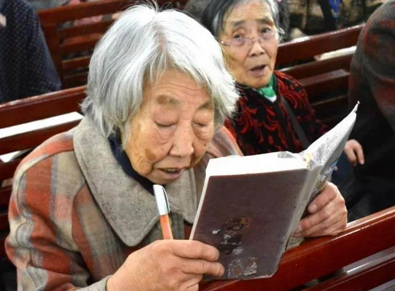 An elderly woman read at a church in China on April 1, 2018.