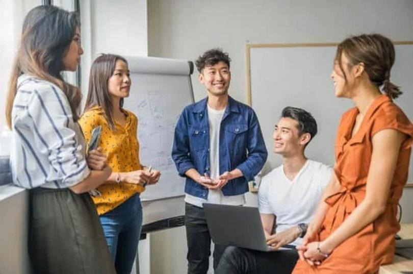 A group of young people discusses at a meeting.