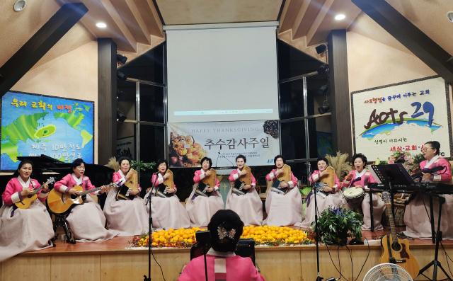 Members of the Enosh Korean Worship performed a hymn in Korean or Mandarin with instruments during the Three Nations Destiny and Unity Conference held at the Jeju International Full Gospel Church (JIFC) in Korea on November 14, 2024.