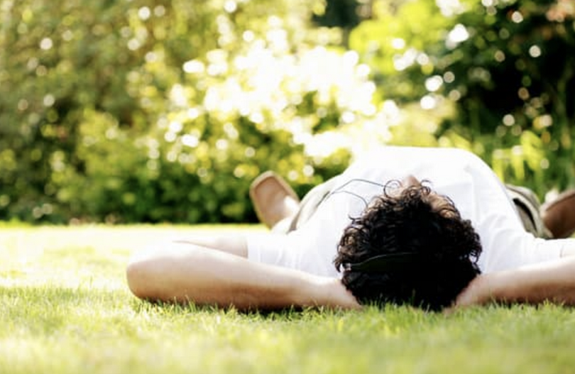 A picture shows a man lying down on the grass.