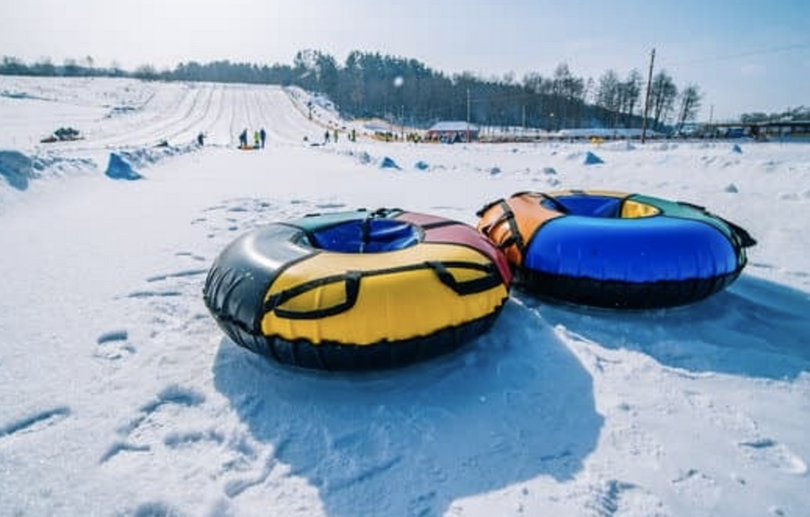 Snow tubing, sleigh on the top of the hill, winter activity