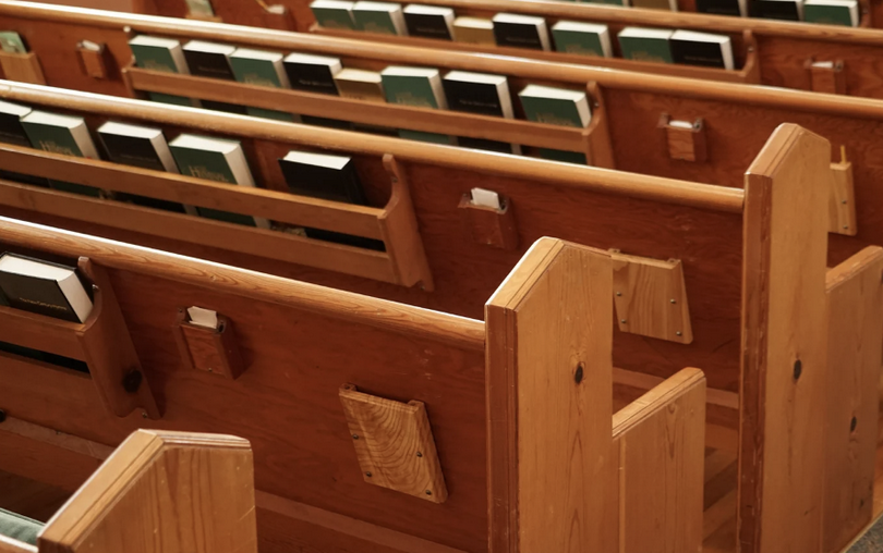 Church pews with bibles on