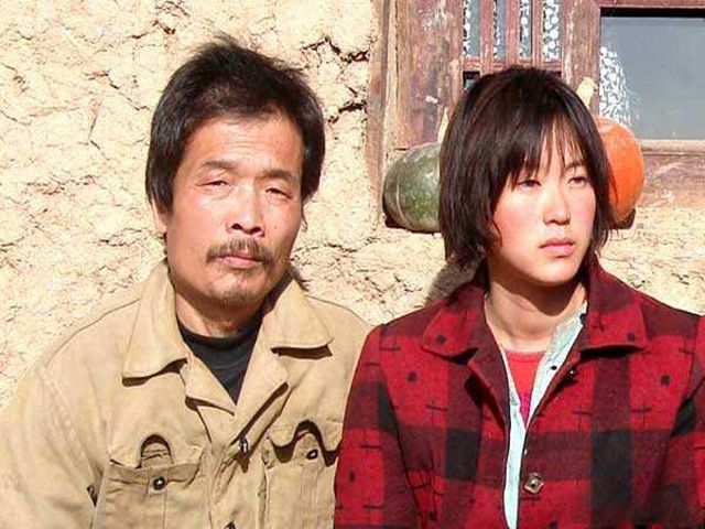 Scene from the movie "Blind Mountain": Bai Xuemei(right), sold as a bride to the villager and her "husband" (left)
