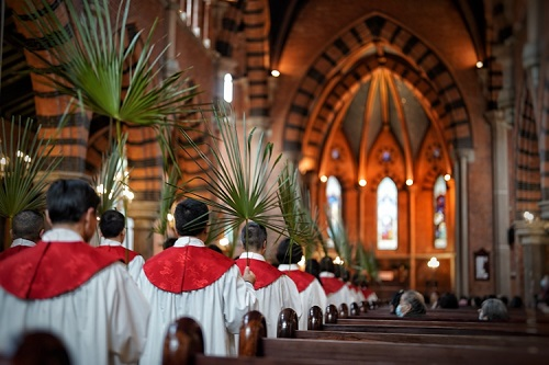 Choir members entered the main building with palm branches to observe the Palm Sunday service conducted at Holy Trinity Cathedral in Shanghai on March 24, 2024.