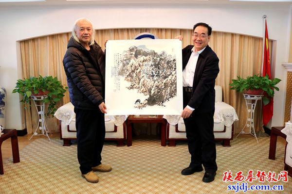 Christian artist Mr. Ding Ping'an (left) is handing over one of his landscape paintings to Rev. Wang Jun (right), president and chairperson of Shaanxi CC&TSPM, in Xi'an City, Shaanxi Province, on November 28, 2024.