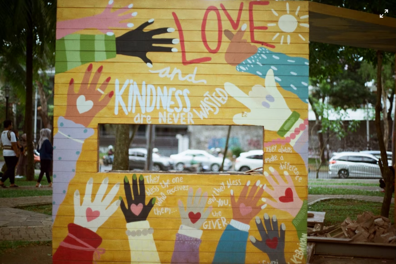 A huge poster was placed on the street showcasing "KINDNESS" and "LOVE."