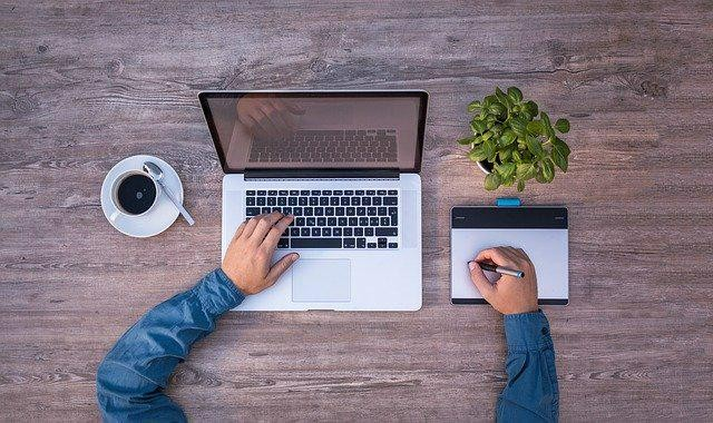 A picture shows a man working on his laptop.