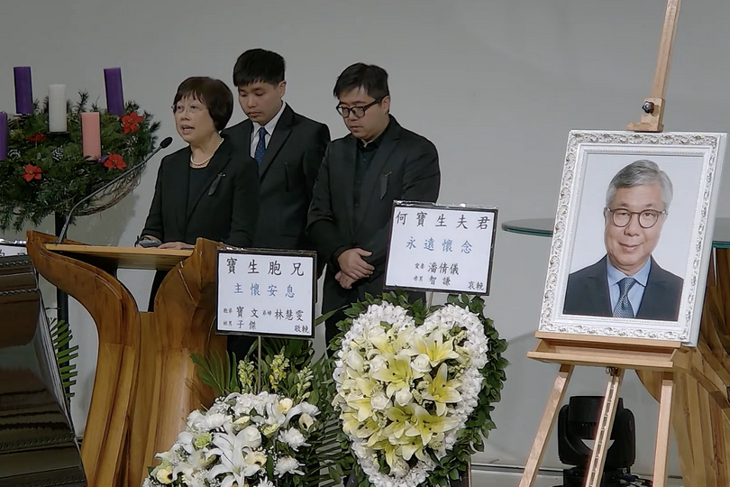 A screenshot of the online video shows Michelle Poon, Andrew Ho's wife, delivering with two sons at “The Celebration of Andrew Ho” memorial service in Hong Kong on December 17, 2024. 