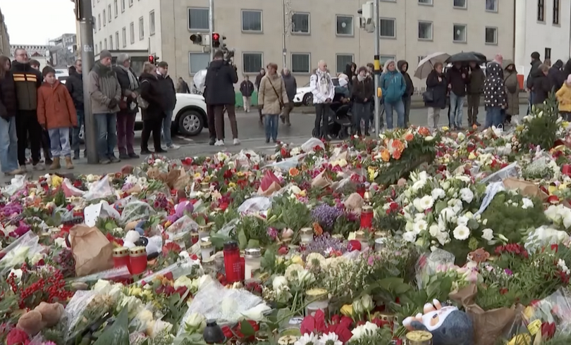 A screenshot from a video of Magdeburg residents grieving after Christmas market attack happened on December 20, 2024