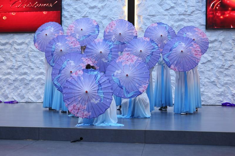 Christians in blue dress perform umbrella dance in celebration of Christmas at Gaizhou Church in Gaizhou City, Liaoning Province, during 2024 Christmas week.