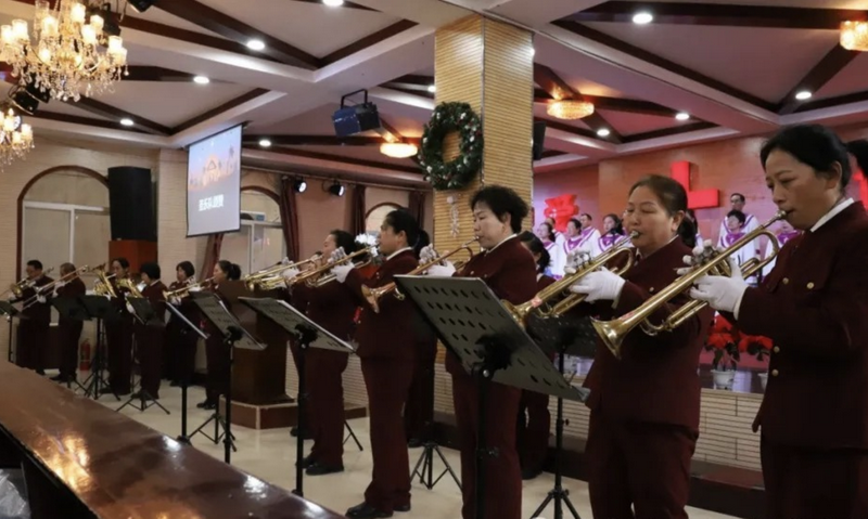 Christians in suits performed instruments to mark Christmas at Chengqu Church in Jincheng City, Shanxi Province, during the week of 2024 Christmas.