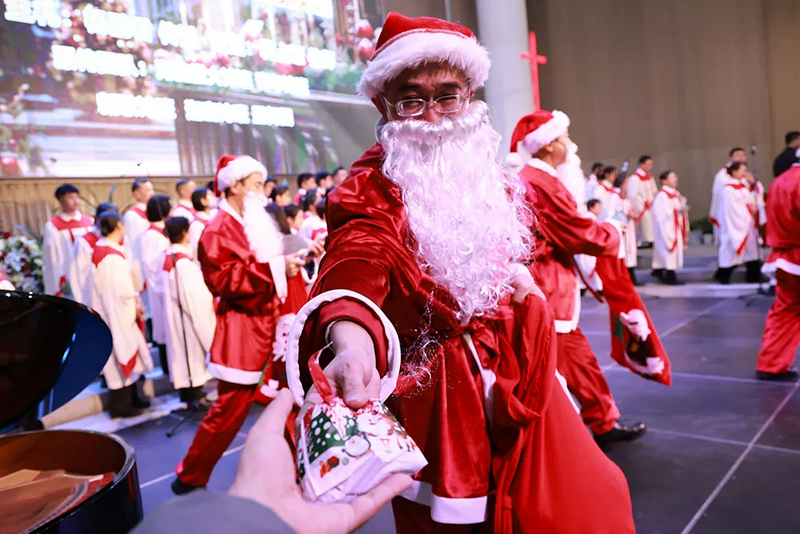 Believers dressed as Santa Claus distributed gifts to the congregation during the Christmas celebration at Haidian Church in Beijing on December 24, 2024.