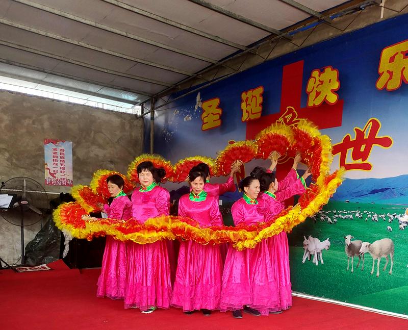 A group of Christian women dressed in pink presented a fan dance in celebration of Christmas at Nankang Church in Beihai City, Guangxi Province, during the week of 2024 Christmas.